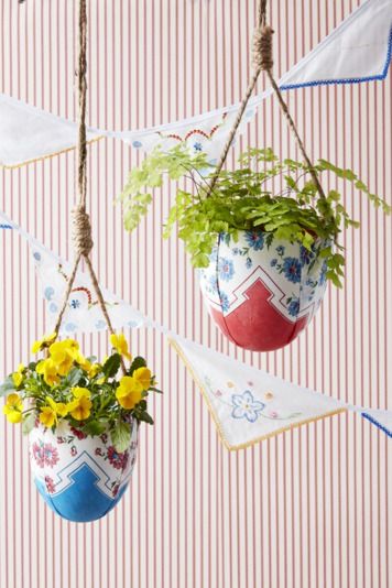 Hanging planters wrapped in scarves with flowers