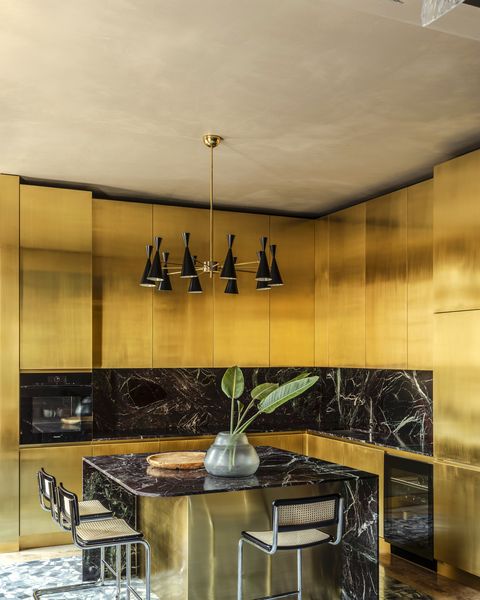 Milan apartment by Hannes Peer with a golden kitchen at its heart