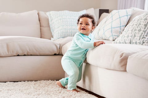 Happy toddler boy playing in sitting room Happy toddler boy playing in sitting room