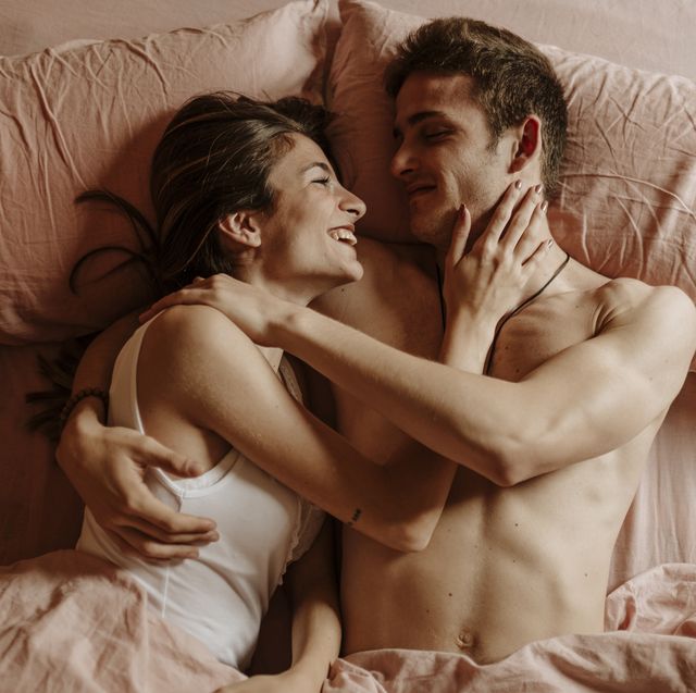 happy young couple lying in bed