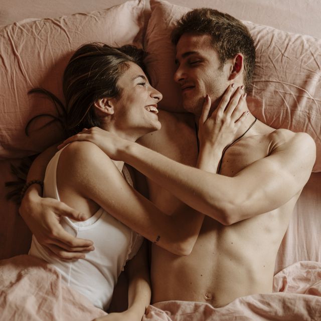 happy young couple lying in bed