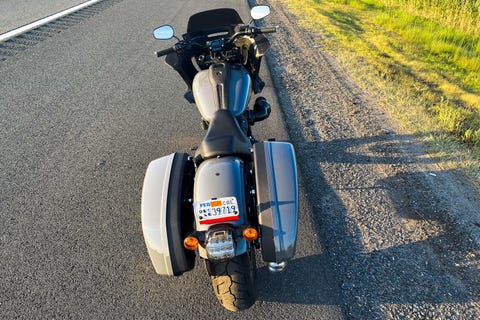 Harley low rider st motorcycle parked on the side of the road