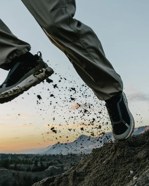 person running across mountain wearing norda quarry sneaker