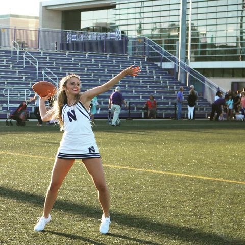 hayden richardson, here in her cheerleading outfit, throwing a football﻿
