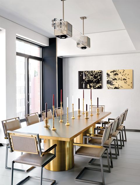 Modern dining room with golden table and gold-trimmed chairs.