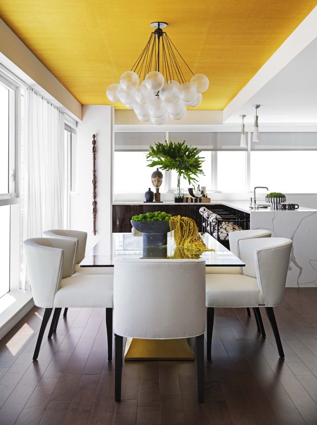 dining room, yellow ceiling, white chairs, plants, marble counter