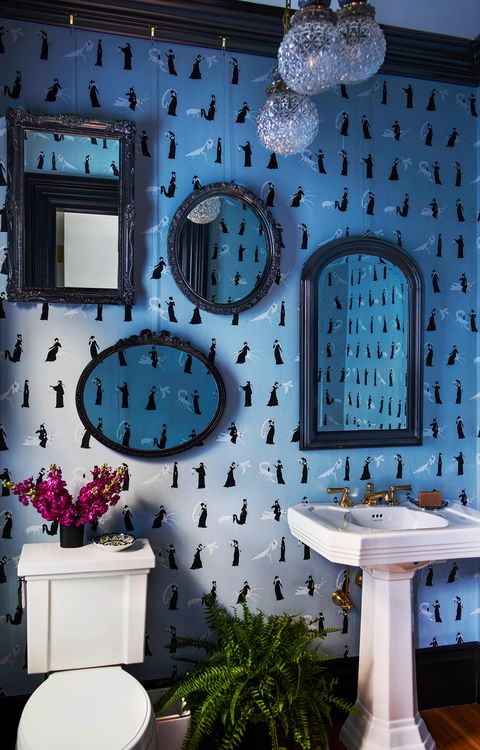 blue bathroom with mirror gallery wall