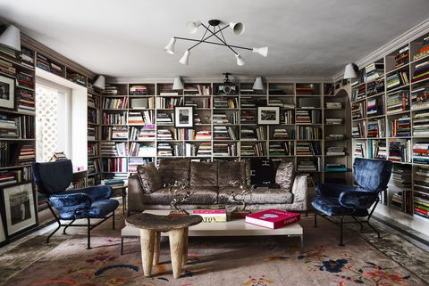 home library designed by romanek design studio featuring wall to wall shelves