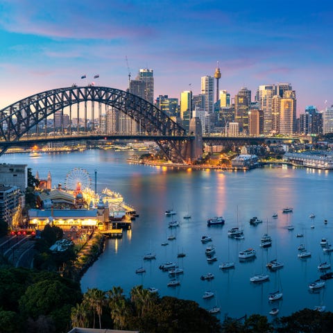 Cityscape image of Sydney, Australia with Harbor Bridge and Sydney skyline during sunset. Vacation and travel in Australia.