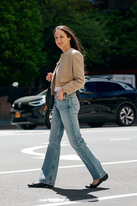 a bazaar editor walks in the street wearing a collarless celine jacket to illustrate the best work outfit ideas 2022