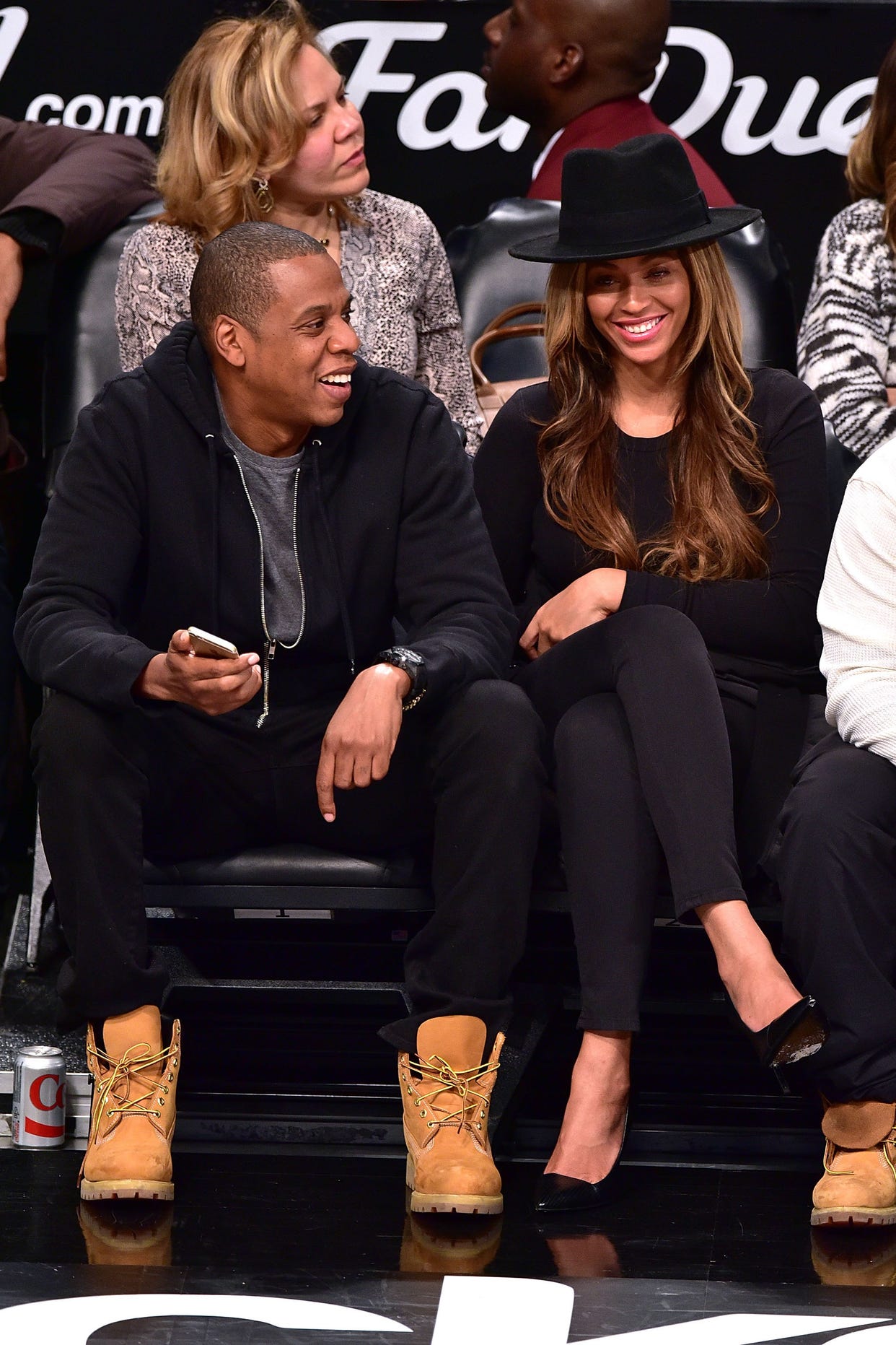 JAY-Z and Beyoncé sit courtside at a Rockets game in 2015.