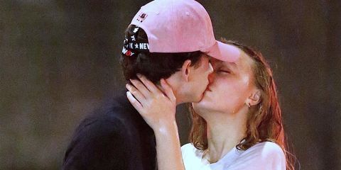 *EXCLUSIVE* Lily-Rose Depp and Timothee Chalamet share a movie scene-esque kiss in the rain **WEB MUST CALL FOR PRICING**