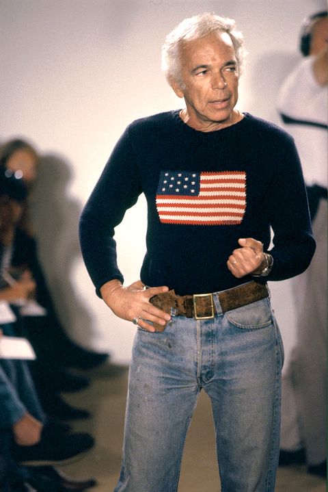 ralph lauren wears jeans and a sweater with the american flag while appearing on the runway