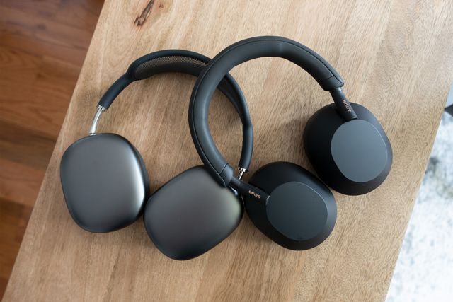 black sony wh 1000xm5 headphones laying on top of black apple airpod max headphones