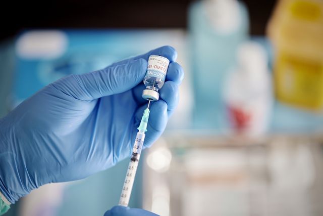 a healthcare worker prepares a dose of covid 19 vaccine