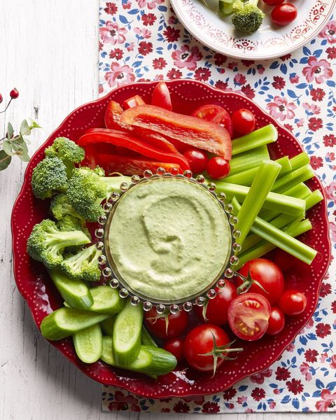 crudites with creamy herb dip on red platter