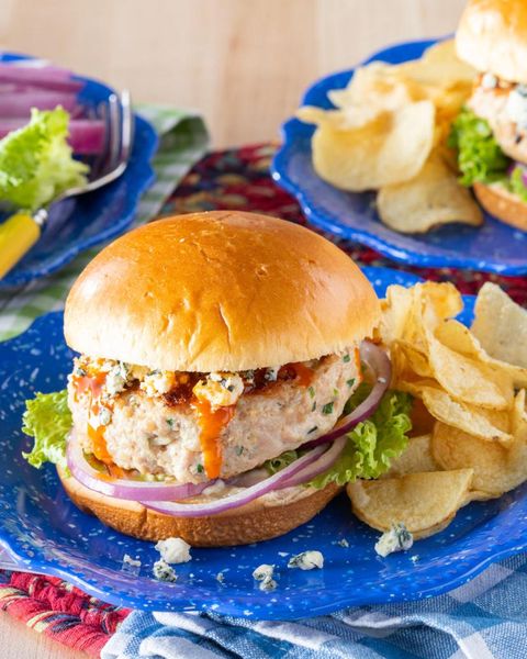 homemade chicken burgers on blue plate with potato chips