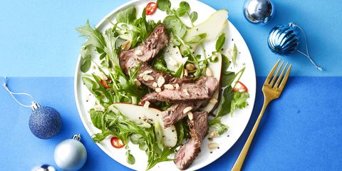 steak and pear salad on a white plate