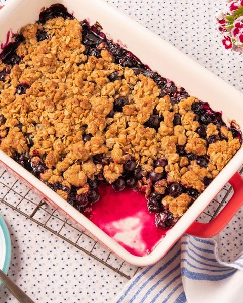 blueberry crumble in red baking dish on wire rack
