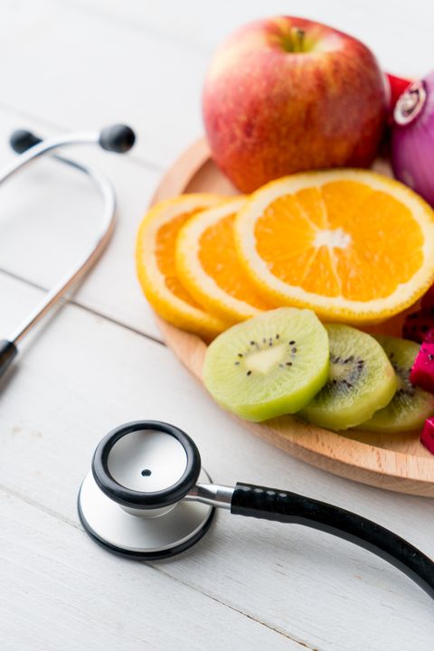 healthy food in heart dish with doctor's stethoscope