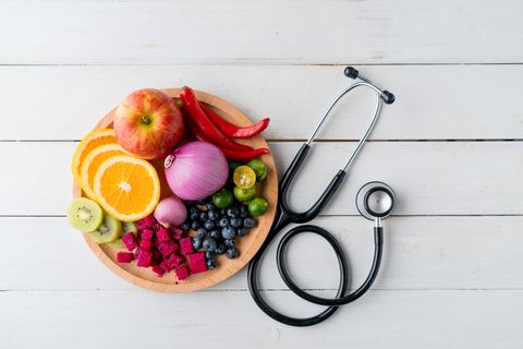 Healthy food in heart dish with doctor's stethoscope
