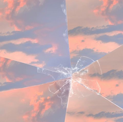 A sunset and cloudy sky with broken glass