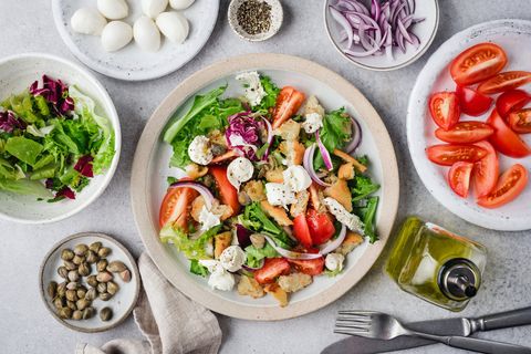 healthy salad with tomatoes, croutons, greens and mozzarella cheese