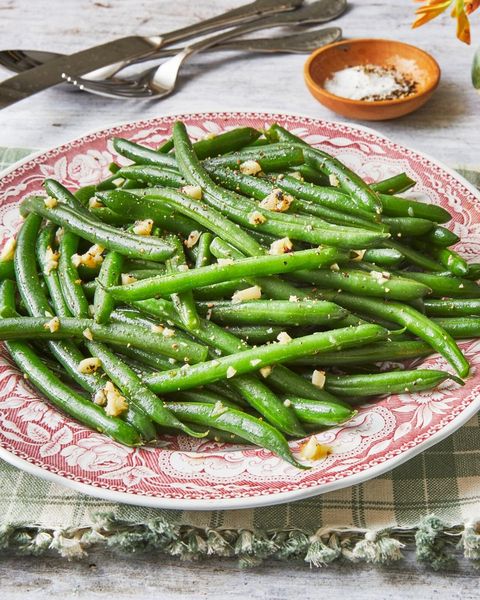 garlic green beans on red and white plate