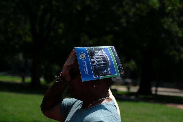 washington, dc   july 20 a man wears a tourism guide on his head to stay cool near the white house during an excessive heat wave on july 20, 2019 in washington, dc an excessive heat warning remains in effect throughout the weekend according to the national weather service photo by alex wroblewskigetty images