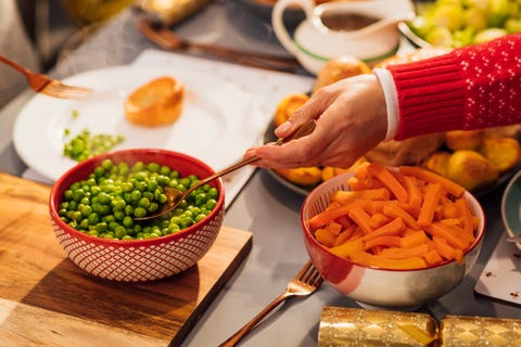 helping herself to the vegetables