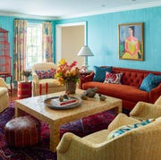 bed wallpaper, orange couch, large coffee table