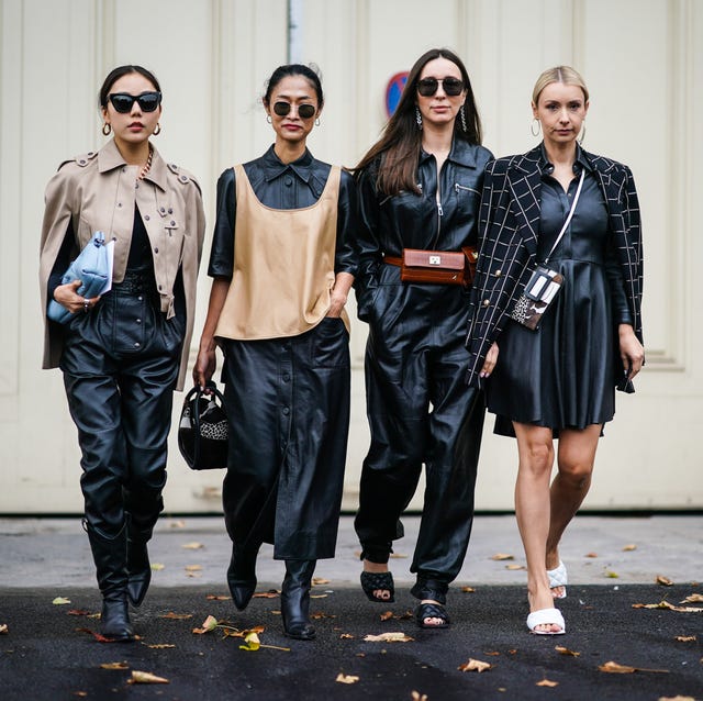 Street Style : Paris Fashion Week - Womenswear Spring Summer 2020 : Day Three paris, france september 25 a guest l wears earrings, sunglasses, a chain necklace, a taupe color jacket, black leather pants, black pointy heeled boots, a blue clutch a guest m1 wears earrings, sunglasses, a beige leather top over a black leather shirt dress, a black bag with white and black cheetah pattern inserts, black pointy heeled boots a guest m2 wears earrings, sunglasses, a black leather jumpsuit, a brown crocodile pattern belt bag, black quilted mules a guest r wears earrings, a black and white windowpane check jacket with brass buttons, a black leather dress, a crossbody bag with different animals pattern, white quilted mules, outside margiela, during paris fashion week womenswear spring summer 2020, on september 25, 2019 in paris, france photo by edward berthelotgetty images