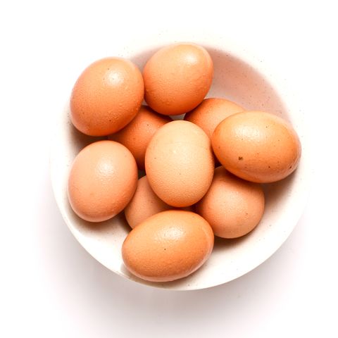 high angle close up view of eggs in a white bowl royalty free image 686787677