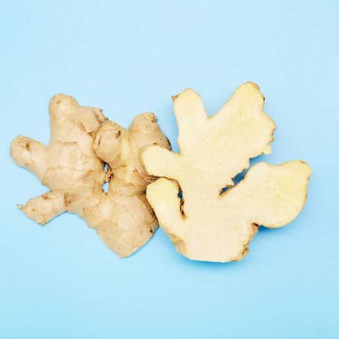 high angle view of a halved ginger root on blue background