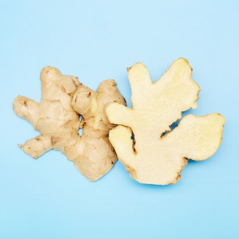 high angle view of a halved ginger root on blue background