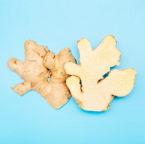 high angle view of a halved ginger root on blue background