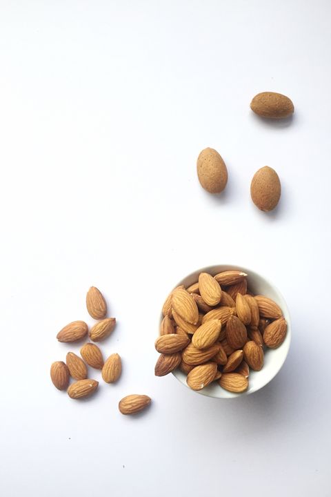 high angle view of almonds in bowl against white background