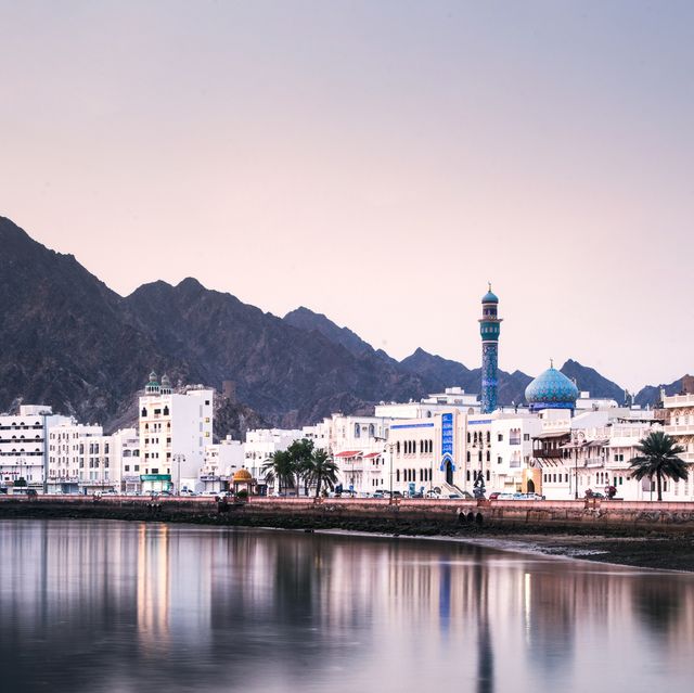 high angle view of buildings and mountains against sky in muscat, oman