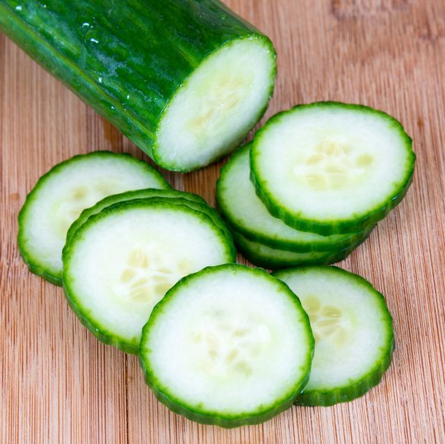 High Angle View Of Cucumber And Its Slices On Cutting Board