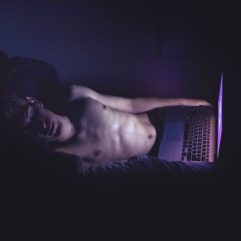 High Angle View Of Man With Laptop Sleeping On Bed At Home