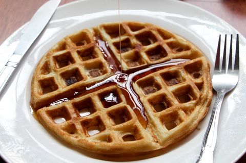 High Angle View Of Maple Syrup Falling On Waffle In Plate