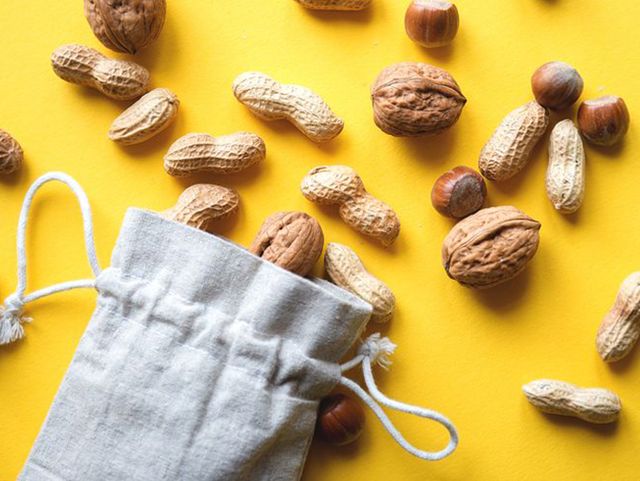 Nuts With Bag On Yellow Background