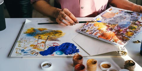 high angle view of person holding painting on table