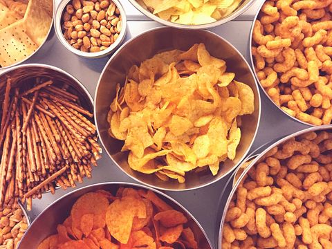 High Angle View Of Various Snacks In Bowls