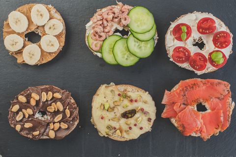Variety of sweet and salty bagels, top view flat lay
