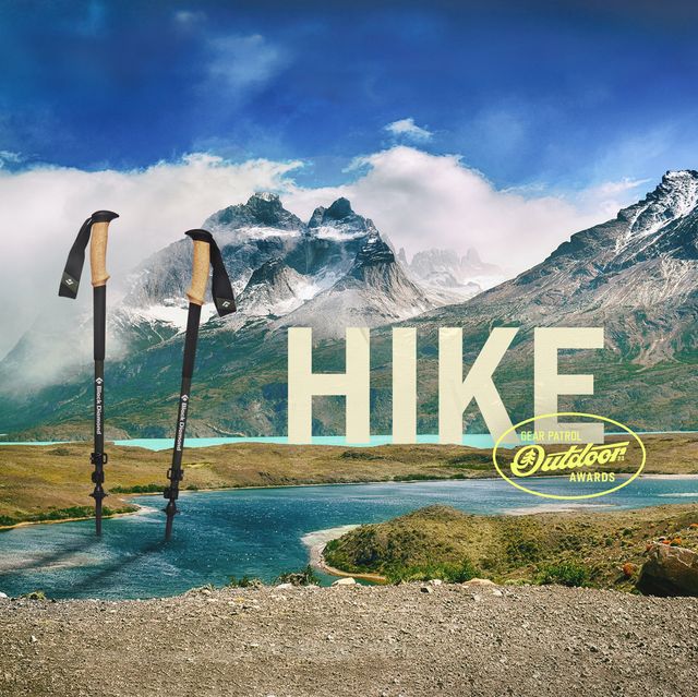 ski poles in a mountain landscape with a hike headline and outdoor badge icon