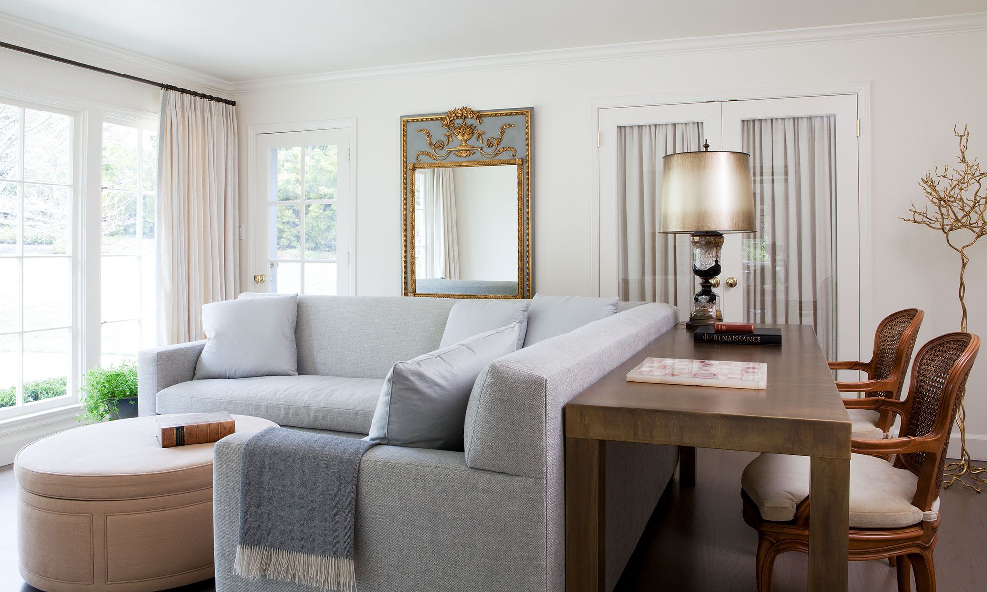 console table and stools behind couch