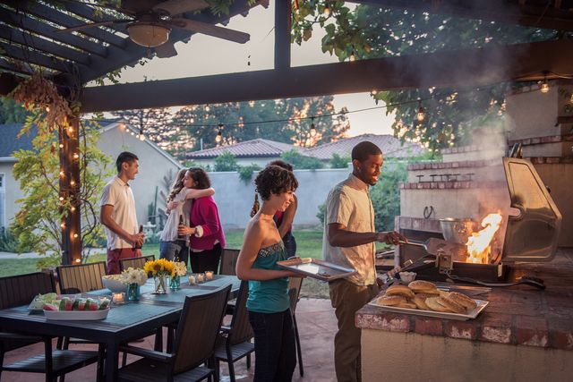 hipsters grilling at a summer backyard bbq