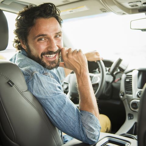 Hispanic man driving car