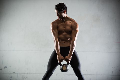 Hispanic Man Working Out With A Kettlebell